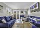 Comfortable living room with a sofa, chairs, tile floors, and a wall-mounted television at 9660 Shore Dr. # 208, Myrtle Beach, SC 29572