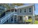 Lovely home exterior boasts a metal roof, large staircase, and gray siding at Tbd Park St., Georgetown, SC 29440