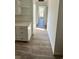 Bright hallway with light walls, wood-look flooring, and view to the window at Tbd Park St., Georgetown, SC 29440