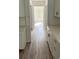 Hallway with wood floors and white cabinets, leading to a naturally lit room at Tbd Park St., Georgetown, SC 29440