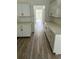 Modern kitchen featuring sleek white cabinets, marble countertops, and wood-look flooring at Tbd Park St., Georgetown, SC 29440
