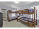Bedroom with carpet and two sets of built in bunk beds with striped linens at 113-A Vista Dr., Garden City Beach, SC 29576