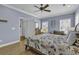 Bedroom features wood floors, ceiling fan, and a large window for natural light at 113-A Vista Dr., Garden City Beach, SC 29576
