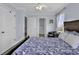 Bedroom with carpet, ceiling fan, three doors, and a large bed with seashell accents at 113-A Vista Dr., Garden City Beach, SC 29576