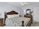 Bedroom with carpet, ceiling fan, and decorative wood frame bed at 113-A Vista Dr., Garden City Beach, SC 29576