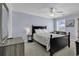 Bedroom with a ceiling fan, a black bed frame, white linens, and neutral toned walls at 113-A Vista Dr., Garden City Beach, SC 29576