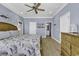 Bedroom features wood floors, a ceiling fan, and a mounted television at 113-A Vista Dr., Garden City Beach, SC 29576