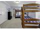 Bright bedroom featuring multiple wood frame bunk beds with blue and white striped bedding at 113-A Vista Dr., Garden City Beach, SC 29576