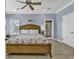 Light and airy bedroom features wood floors, ceiling fan, and access to the outside at 113-A Vista Dr., Garden City Beach, SC 29576