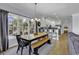 Bright dining area with a large window, a wooden table, and access to the modern kitchen at 113-A Vista Dr., Garden City Beach, SC 29576