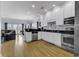 Modern kitchen with white cabinetry, stainless steel appliances, and an open layout to the living area at 113-A Vista Dr., Garden City Beach, SC 29576