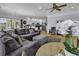 Inviting living room with a plush sectional sofa, hardwood floors, and a view into a modern white kitchen at 113-A Vista Dr., Garden City Beach, SC 29576