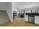 An open-concept living space featuring hardwood floors, a comfortable sofa, and direct access to the kitchen at 113-A Vista Dr., Garden City Beach, SC 29576