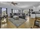 Inviting open-concept living room with hardwood floors, comfortable seating, and adjacent kitchen area at 113-A Vista Dr., Garden City Beach, SC 29576