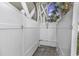 Enclosed outdoor shower with white vinyl walls, stone floor and a shower head at 113-A Vista Dr., Garden City Beach, SC 29576