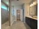 Elegant bathroom with double sinks, tiled shower, and a walk-in closet at 1241 Beeblossom Dr., North Myrtle Beach, SC 29582