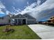 Well-manicured lawn of a blue-sided, single-story home with a two-car garage at 1241 Beeblossom Dr., North Myrtle Beach, SC 29582