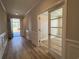 Inviting hallway with light wood floors and a glass-paneled door at 1241 Beeblossom Dr., North Myrtle Beach, SC 29582