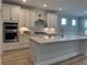 Modern kitchen with stainless steel appliances, white cabinets, and an island at 1241 Beeblossom Dr., North Myrtle Beach, SC 29582