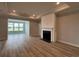 Bright living room featuring a fireplace, tray ceilings, and a sunroom at 1241 Beeblossom Dr., North Myrtle Beach, SC 29582