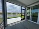 Screened-in porch with a view of the backyard, pond, and neighboring homes at 1241 Beeblossom Dr., North Myrtle Beach, SC 29582