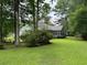 Serene backyard view with lush greenery, trees, and an outdoor seating area at 125 Gavin Hill Ct., Aynor, SC 29511