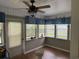 Cozy sun room with plenty of windows, tongue-and-groove paneling, and a ceiling fan at 125 Gavin Hill Ct., Aynor, SC 29511