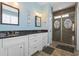 Modern bathroom with double sink vanity, granite countertop, tiled floors and a large glass shower at 128 Lake Pointe Dr., Murrells Inlet, SC 29576