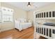 Bright bedroom featuring a daybed, bunk beds, ceiling fan, and hardwood floors at 128 Lake Pointe Dr., Murrells Inlet, SC 29576