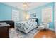 Bedroom with hardwood floors, ceiling fan, an armchair, and two windows for natural light at 128 Lake Pointe Dr., Murrells Inlet, SC 29576