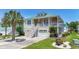 Charming two-story home features a metal roof, upper porch, well-maintained lawn, and a palm tree at 128 Lake Pointe Dr., Murrells Inlet, SC 29576