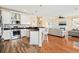 Open kitchen with stainless steel appliances, island, and a view into the living room at 128 Lake Pointe Dr., Murrells Inlet, SC 29576