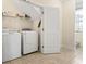 Convenient laundry room with tiled flooring, washer, dryer, storage, and natural light at 128 Lake Pointe Dr., Murrells Inlet, SC 29576