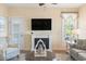 Comfortable living room featuring a fireplace, ceiling fan and hardwood flooring at 128 Lake Pointe Dr., Murrells Inlet, SC 29576