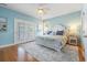 Spacious main bedroom with a ceiling fan, hardwood floors, and glass doors that lead to a balcony at 128 Lake Pointe Dr., Murrells Inlet, SC 29576
