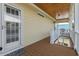 Cozy porch with wood ceiling, storm door, and access to the main house and lower level at 128 Lake Pointe Dr., Murrells Inlet, SC 29576