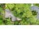 Aerial view of home showcasing the roof, landscaping, driveway, and surrounding trees at 15 Cherbourg Ct., Pawleys Island, SC 29585
