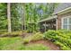 Beautiful backyard featuring a screened porch and lush landscaping around a pergola at 15 Cherbourg Ct., Pawleys Island, SC 29585