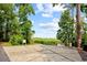 Community entrance gate surrounded by lush greenery under a blue sky at 15 Cherbourg Ct., Pawleys Island, SC 29585