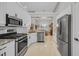 Updated kitchen with stainless steel appliances, granite countertops, and white cabinetry at 15 Cherbourg Ct., Pawleys Island, SC 29585
