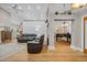 Open-concept living room showcasing hardwood floors and comfortable leather seating at 15 Cherbourg Ct., Pawleys Island, SC 29585