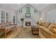 Cozy living room featuring a fireplace, neutral colors, and ample natural light at 15 Cherbourg Ct., Pawleys Island, SC 29585