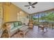Comfortable porch with wicker seating, ceiling fan, and views of the pond at 15 Cherbourg Ct., Pawleys Island, SC 29585