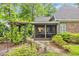 Inviting screened porch and outdoor living space with adjacent pergola in backyard at 15 Cherbourg Ct., Pawleys Island, SC 29585