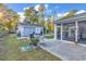 Backyard with green grass and walkway to the screened patio and separate garage at 156 Hummingbird Ct., Myrtle Beach, SC 29579