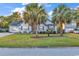 Charming brick home featuring a well-manicured lawn and mature palm trees at 156 Hummingbird Ct., Myrtle Beach, SC 29579