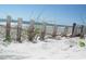 Beach view with rustic fence and vegetation overlooking the ocean at 161 Easy St., Garden City Beach, SC 29576