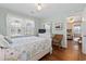 Light and airy bedroom with a coastal themed comforter and wood floors at 161 Easy St., Garden City Beach, SC 29576