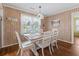 Dining room featuring wood walls, a white table, and views to the outside at 161 Easy St., Garden City Beach, SC 29576