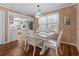 Dining room with white table and wood walls with a view into the kitchen at 161 Easy St., Garden City Beach, SC 29576